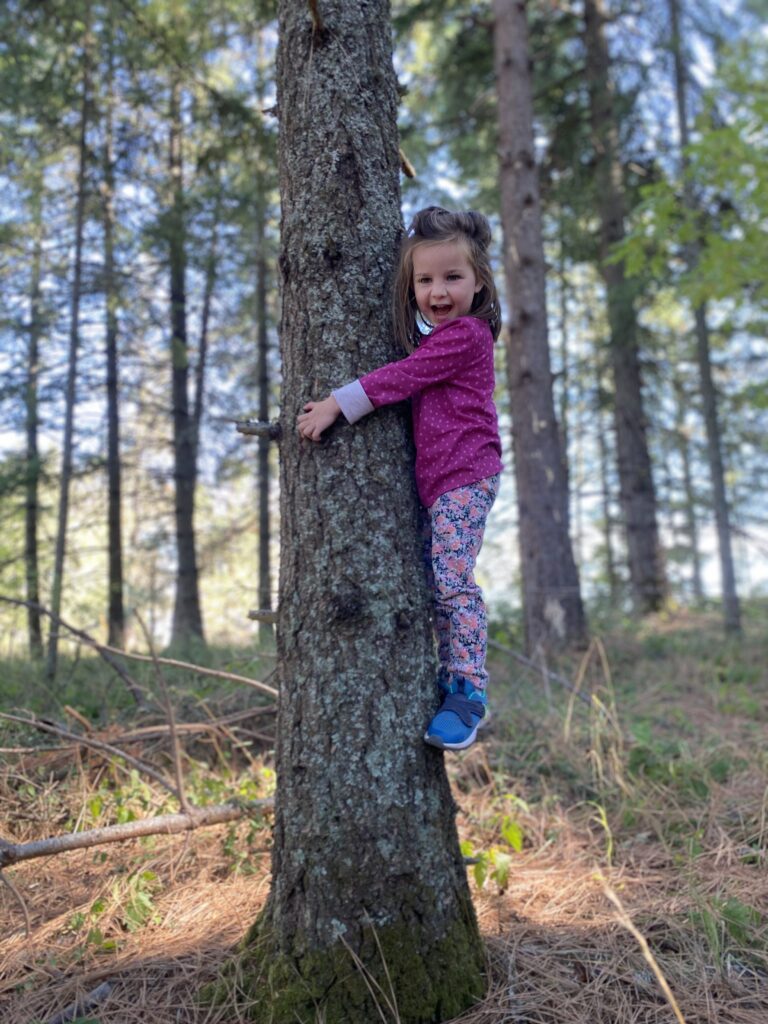 Child climbing and playing at preschool in Eugene, Oregon